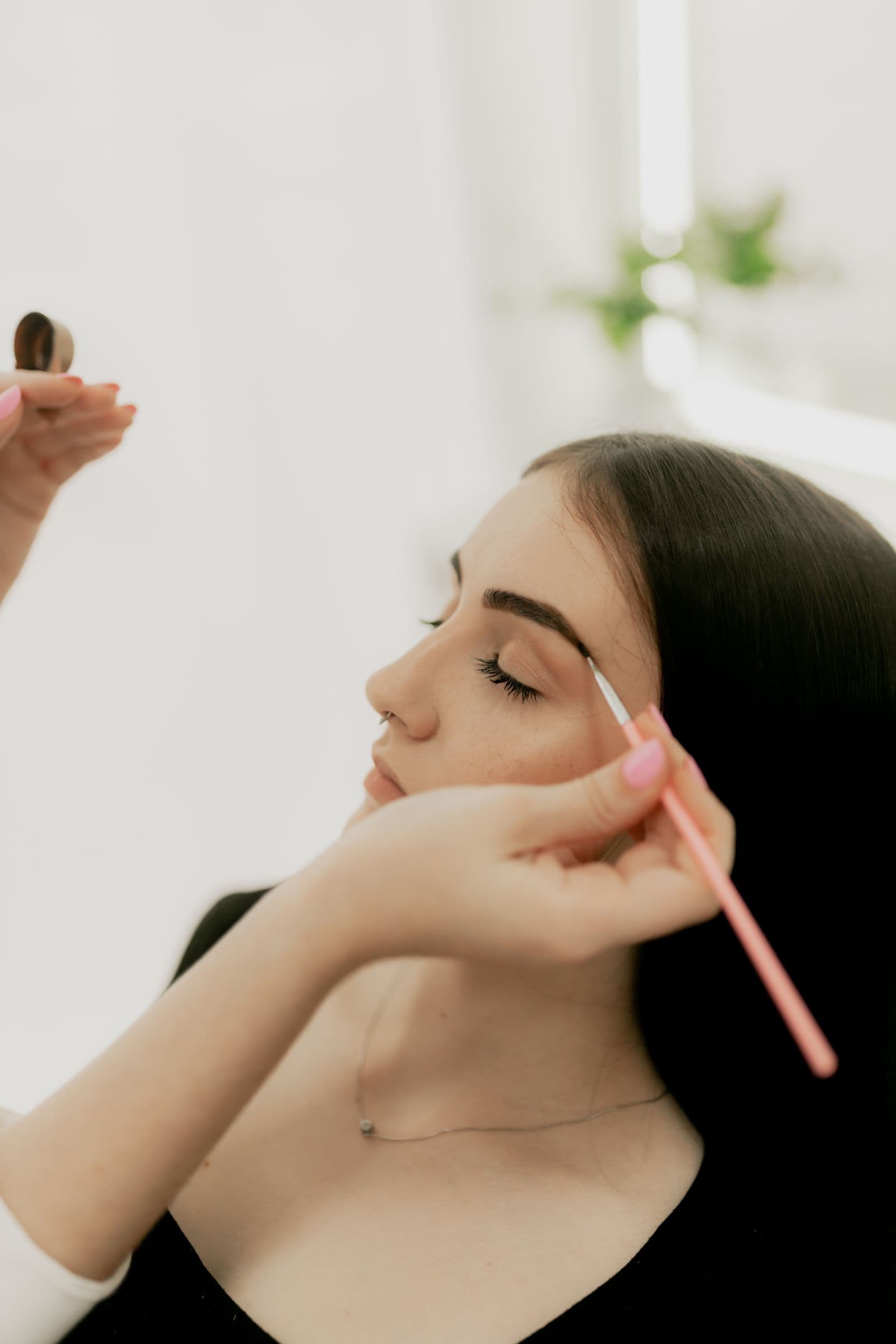 Close-up of a brow being groomed during a treatment