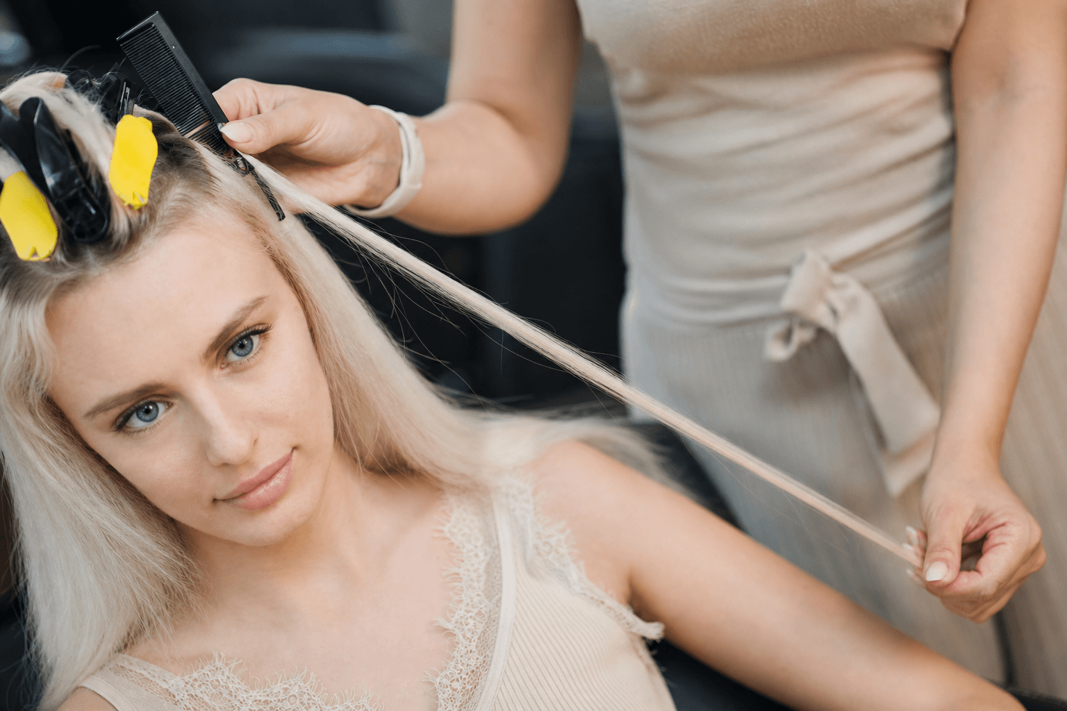 Individual keratin bond hair extensions being applied strand by strand